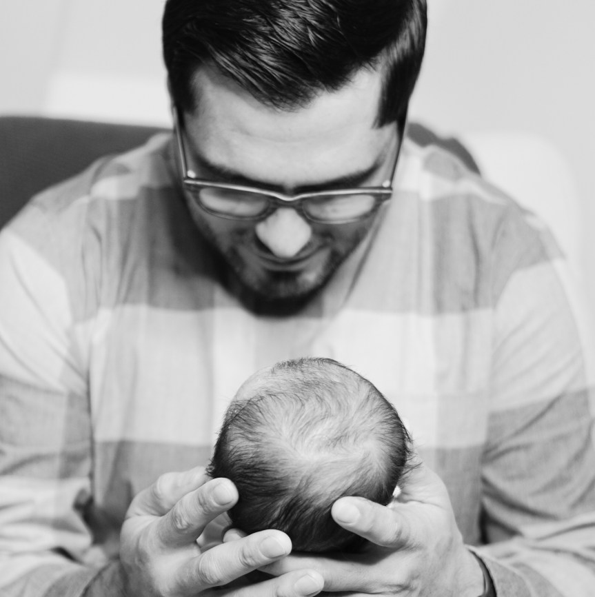 man holding baby-unsplash